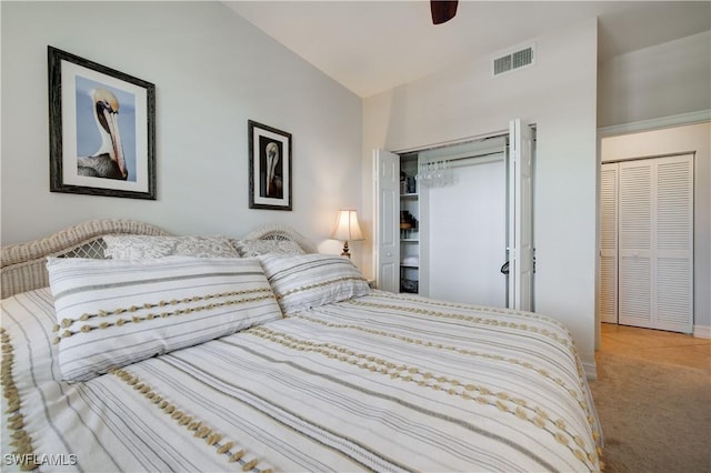 bedroom with ceiling fan, lofted ceiling, carpet floors, and a closet