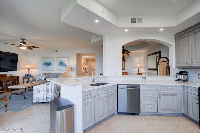 kitchen featuring dishwasher, sink, ceiling fan, gray cabinets, and kitchen peninsula