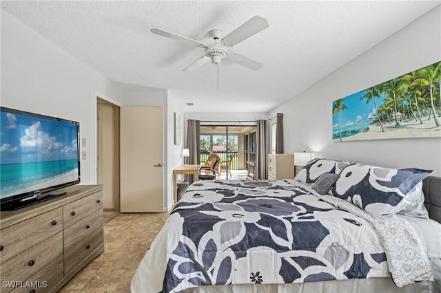 carpeted bedroom featuring a textured ceiling and ceiling fan