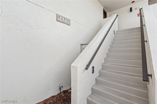 stairs with a textured wall