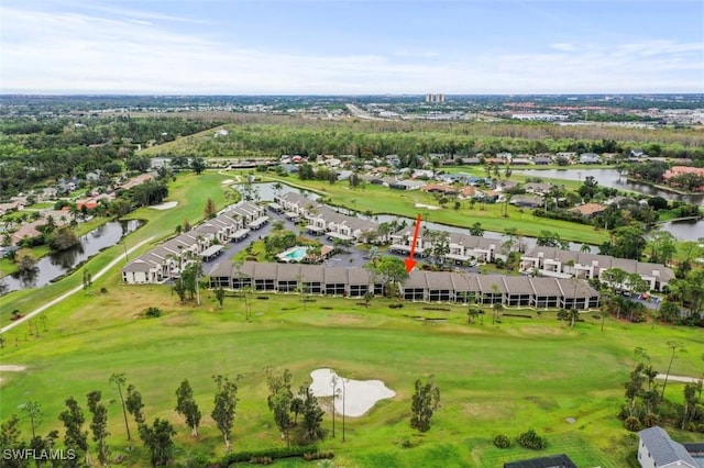 drone / aerial view featuring view of golf course, a water view, and a residential view