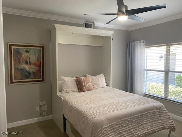 carpeted bedroom featuring ceiling fan and ornamental molding