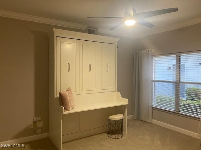 mudroom with ceiling fan, light colored carpet, and ornamental molding