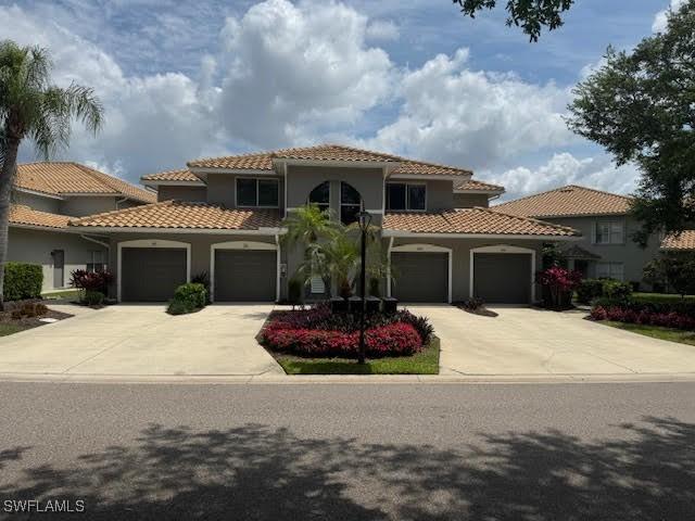 mediterranean / spanish-style home with a garage