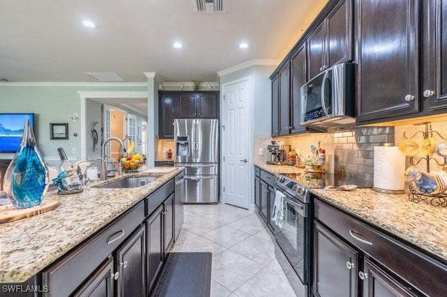 kitchen featuring light stone countertops, sink, stainless steel appliances, decorative backsplash, and light tile patterned floors