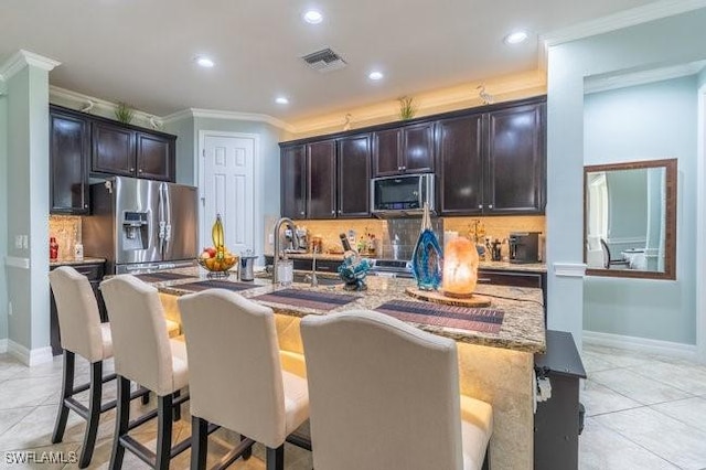 kitchen featuring black microwave, stainless steel fridge with ice dispenser, light tile patterned floors, and ornamental molding