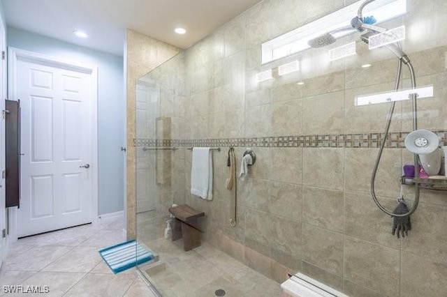 bathroom with tile patterned flooring and a tile shower