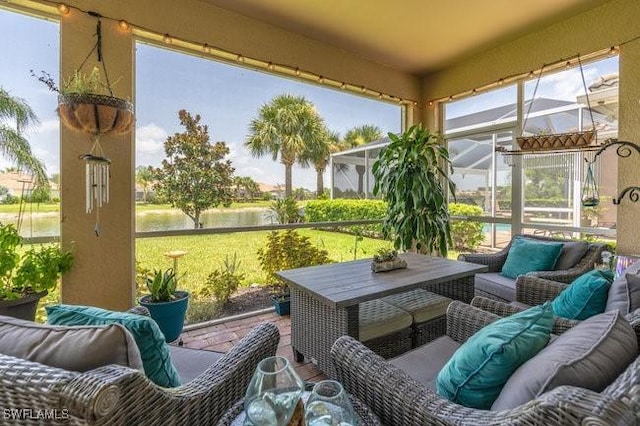 sunroom / solarium featuring a water view