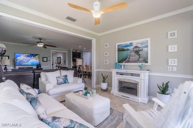 tiled living room featuring ceiling fan and crown molding