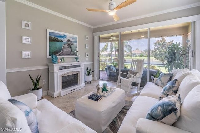 living room featuring light tile patterned floors, ceiling fan, and crown molding