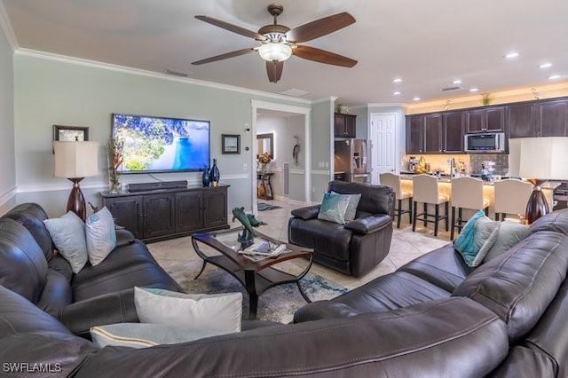 living room featuring crown molding and ceiling fan