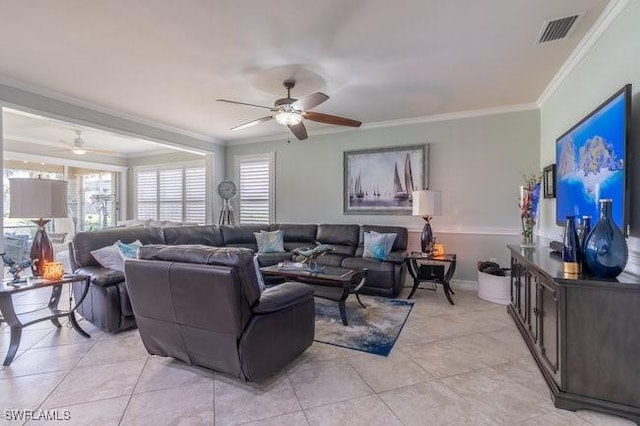 tiled living room with ceiling fan and ornamental molding