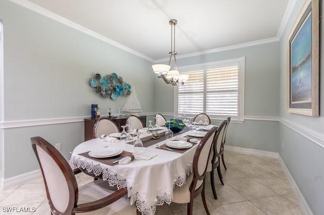 tiled dining room featuring an inviting chandelier and ornamental molding