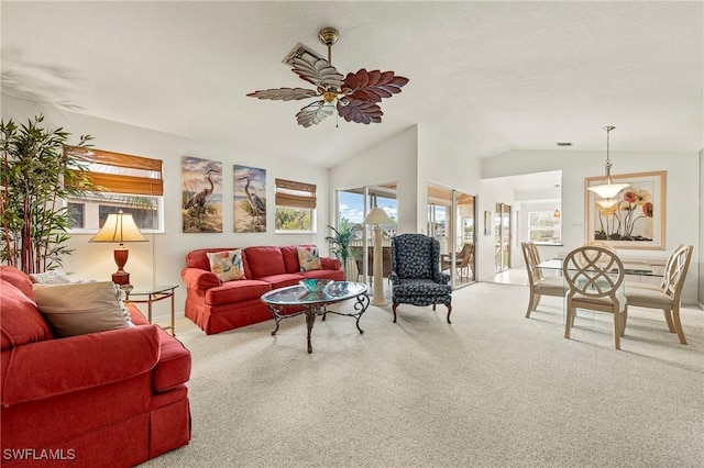 carpeted living room featuring vaulted ceiling and ceiling fan