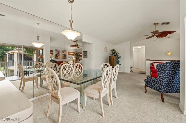 carpeted dining space featuring ceiling fan and lofted ceiling