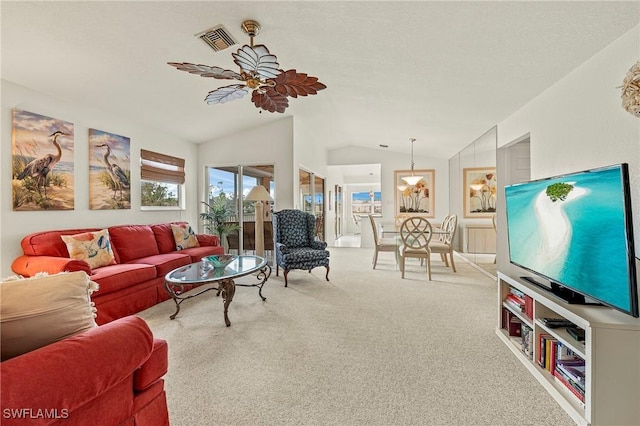 living room with carpet flooring, ceiling fan, and vaulted ceiling