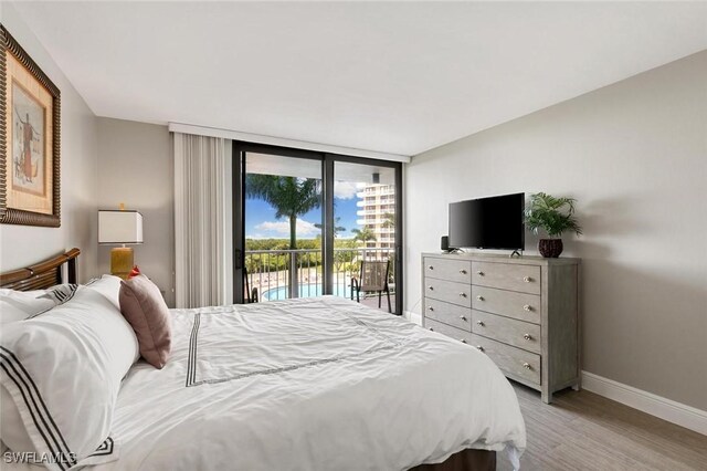 bedroom with floor to ceiling windows, light hardwood / wood-style floors, and access to outside