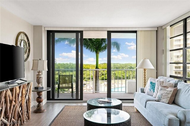 living room with expansive windows and hardwood / wood-style flooring