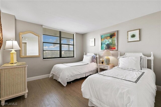 bedroom with dark wood-type flooring