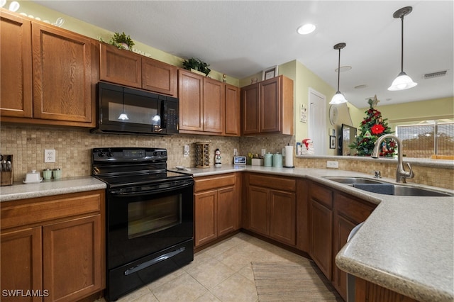 kitchen with decorative backsplash, sink, light tile patterned flooring, and black appliances