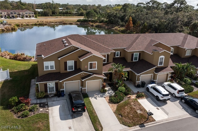 birds eye view of property with a water view