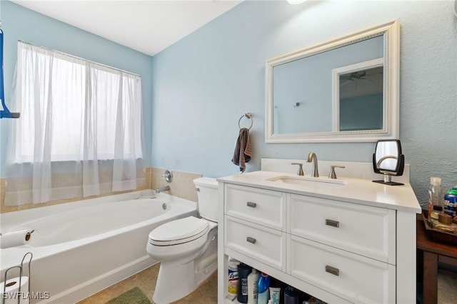 bathroom featuring a washtub, tile patterned floors, vanity, and toilet