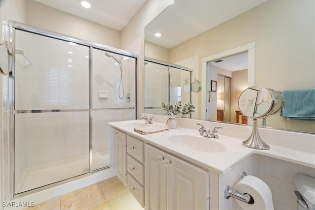 bathroom with tile patterned floors, vanity, and a shower with shower door