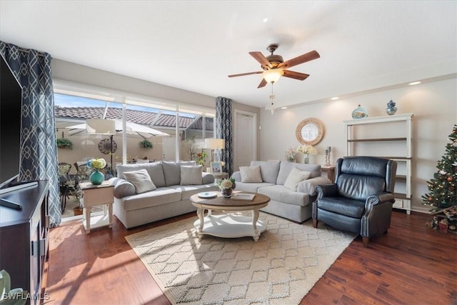 living room featuring ceiling fan, a baseboard radiator, and dark hardwood / wood-style floors