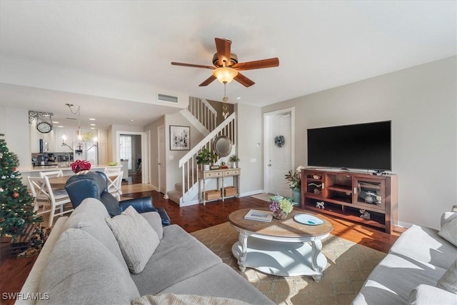 living room with ceiling fan and dark wood-type flooring