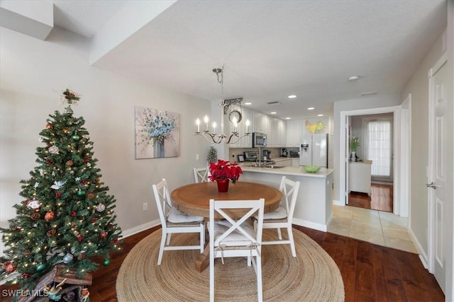 dining room featuring light hardwood / wood-style floors and a notable chandelier