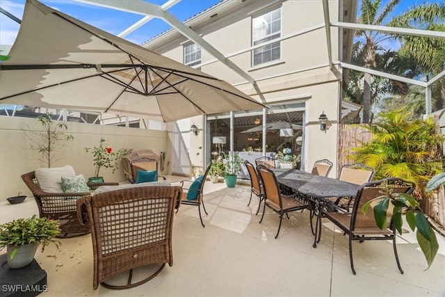 view of patio / terrace featuring glass enclosure and an outdoor hangout area