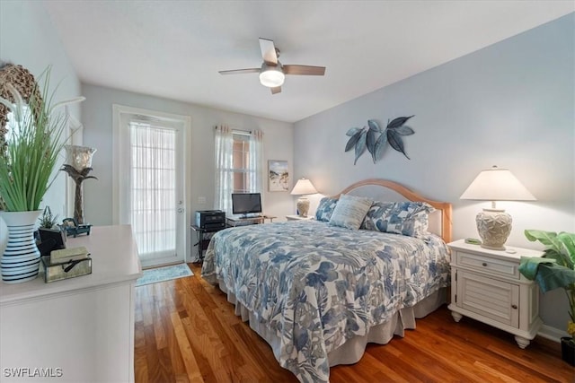 bedroom with access to exterior, ceiling fan, and dark hardwood / wood-style floors