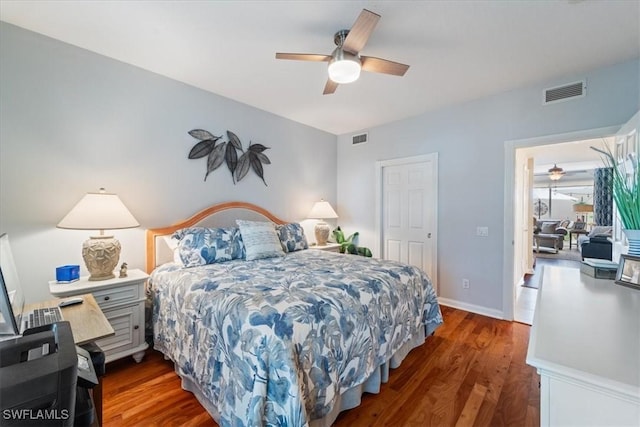 bedroom with ceiling fan and dark wood-type flooring