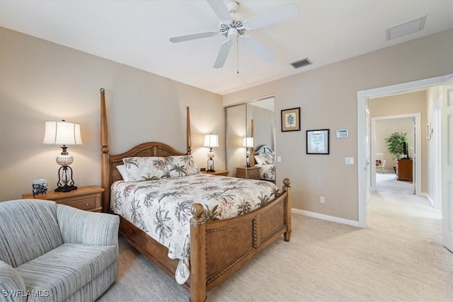 bedroom with ceiling fan, a closet, and light carpet