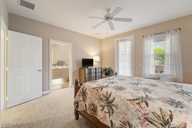 bedroom with carpet, ensuite bathroom, and ceiling fan