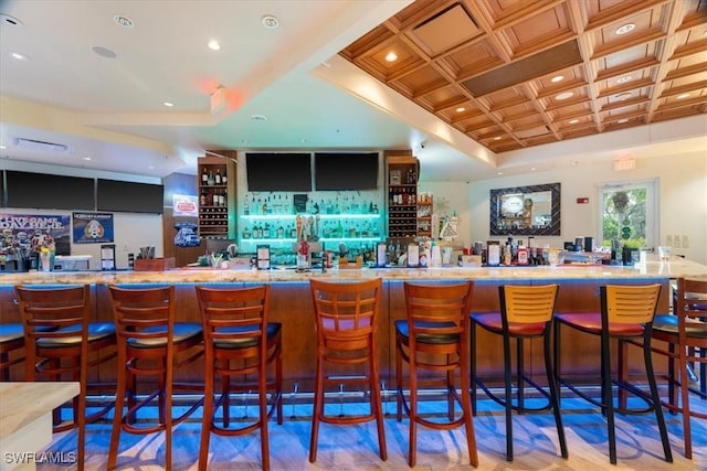 bar featuring coffered ceiling