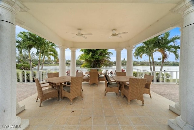 view of patio featuring ceiling fan and a water view