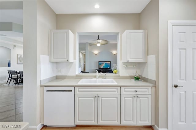 kitchen featuring ceiling fan, white cabinetry, dishwasher, and sink