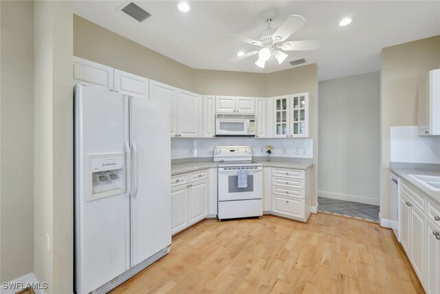 kitchen with ceiling fan, sink, white appliances, white cabinetry, and light hardwood / wood-style flooring