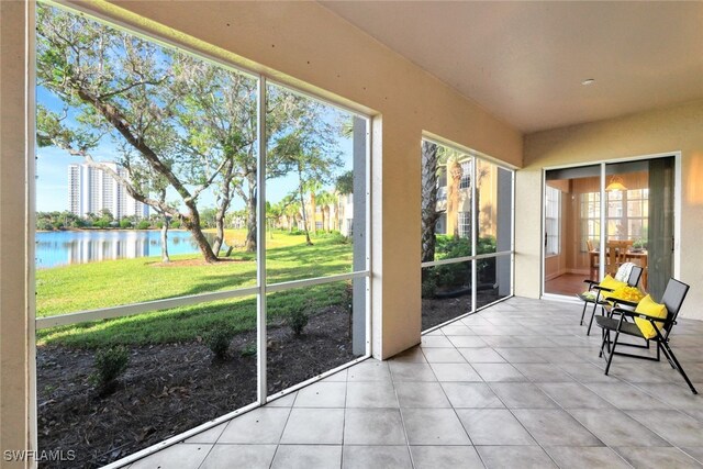 unfurnished sunroom with a water view