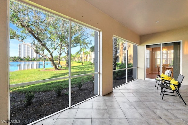 unfurnished sunroom featuring a water view