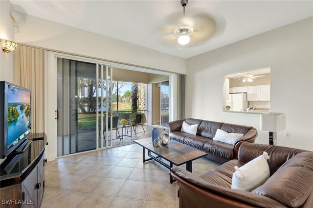 living room with ceiling fan and light tile patterned flooring