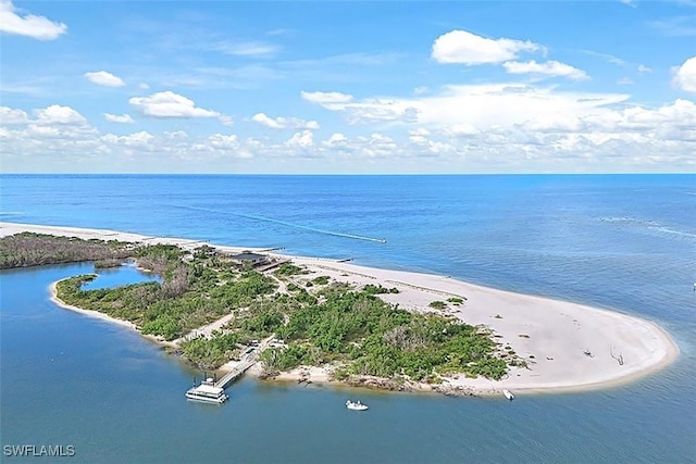 birds eye view of property featuring a water view and a beach view