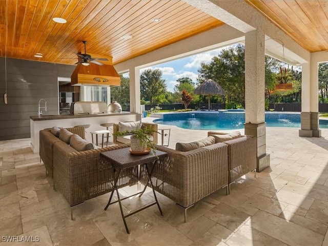 view of pool with area for grilling, a patio area, ceiling fan, and an outdoor hangout area