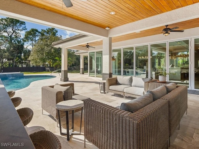 view of patio / terrace with pool water feature, an outdoor living space, ceiling fan, and a fenced in pool