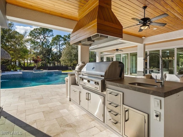 view of patio with sink, area for grilling, and a pool with hot tub