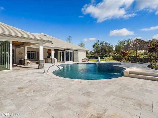 view of pool featuring pool water feature, ceiling fan, an in ground hot tub, and a patio