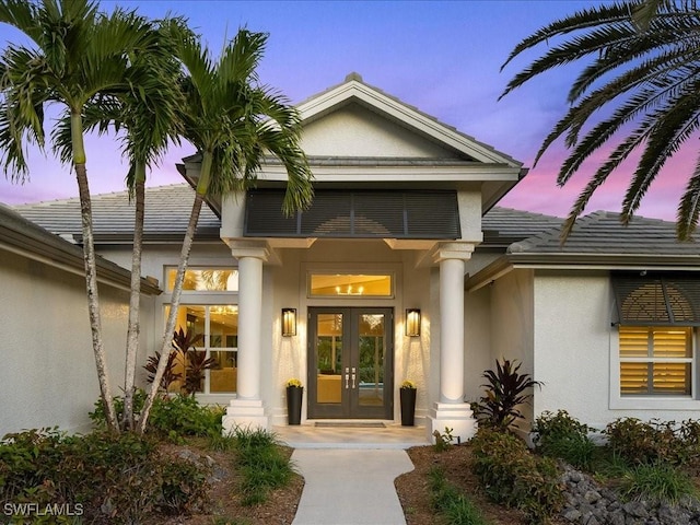 exterior entry at dusk with french doors