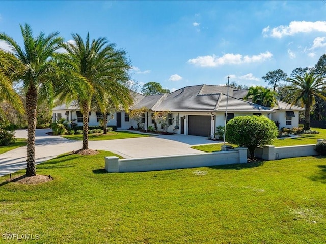 ranch-style house featuring a garage and a front yard