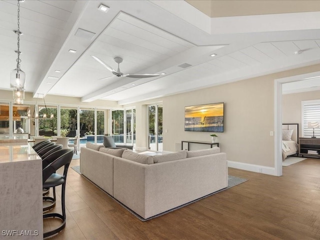 living room with beam ceiling, dark hardwood / wood-style floors, and ceiling fan